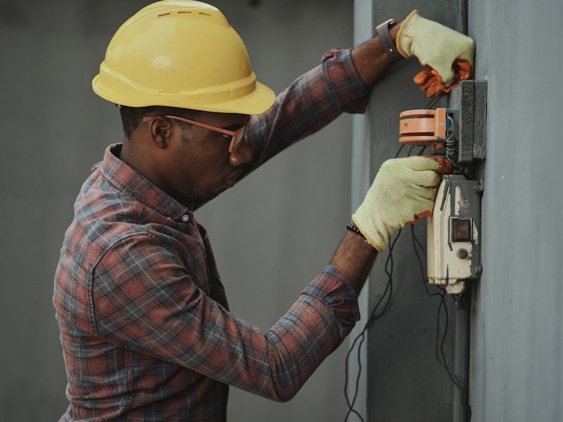 Technician integrating security and control wiring at an exterior installation